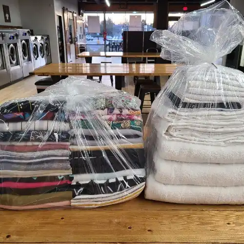 Folded and packaged wash and fold items.